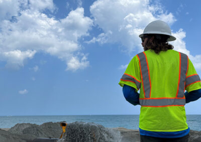 A First Line Coastal team member performing construction inspections at the beach placement area